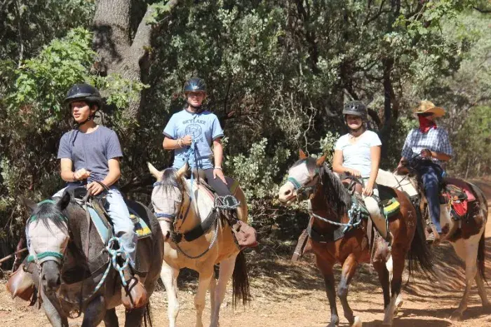Campers riding horses