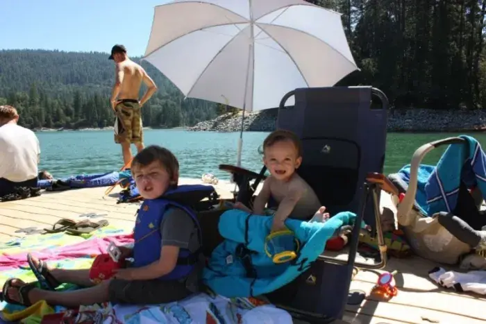 Kids under beach umbrella
