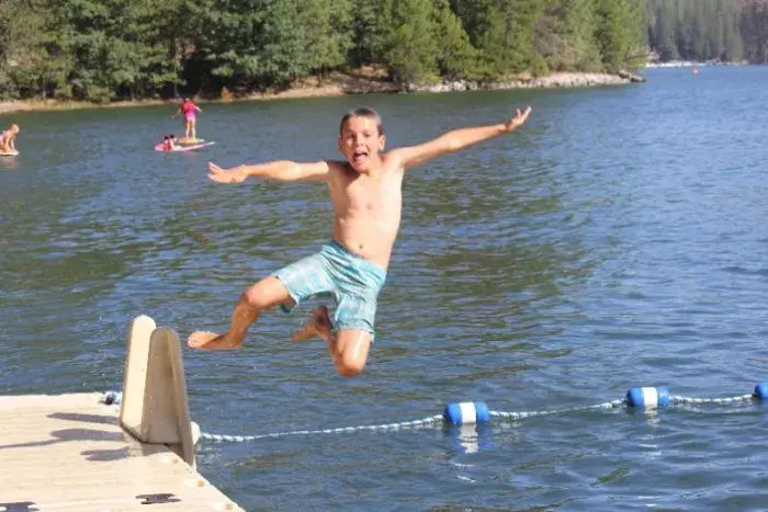 Camper jumping in lake
