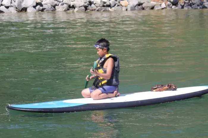 Camper on paddleboard