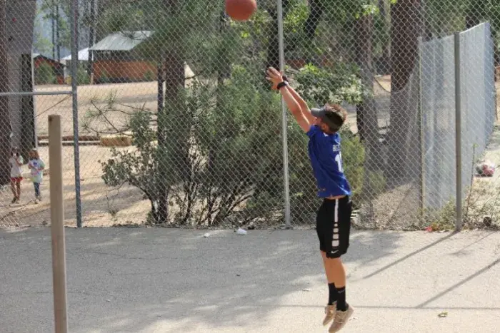 Camper shooting basketball
