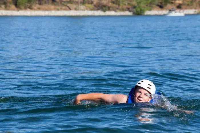 Boy swimming in bass lake