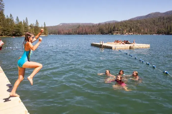 Girl jumping off dock
