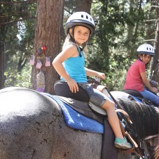 Camper on horse smiling